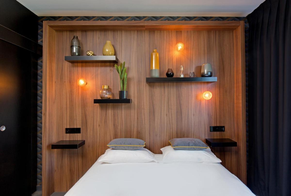 Un ou plusieurs lits dans un hébergement de l'établissement Hôtel Montmorency & Spa