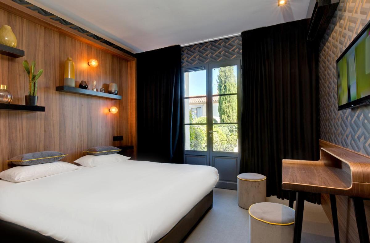 Un ou plusieurs lits dans un hébergement de l'établissement Hôtel Montmorency & Spa