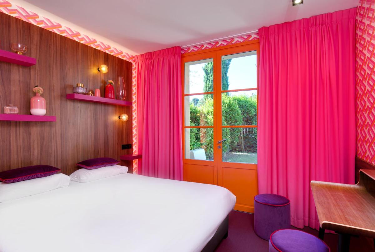 Un ou plusieurs lits dans un hébergement de l'établissement Hôtel Montmorency & Spa