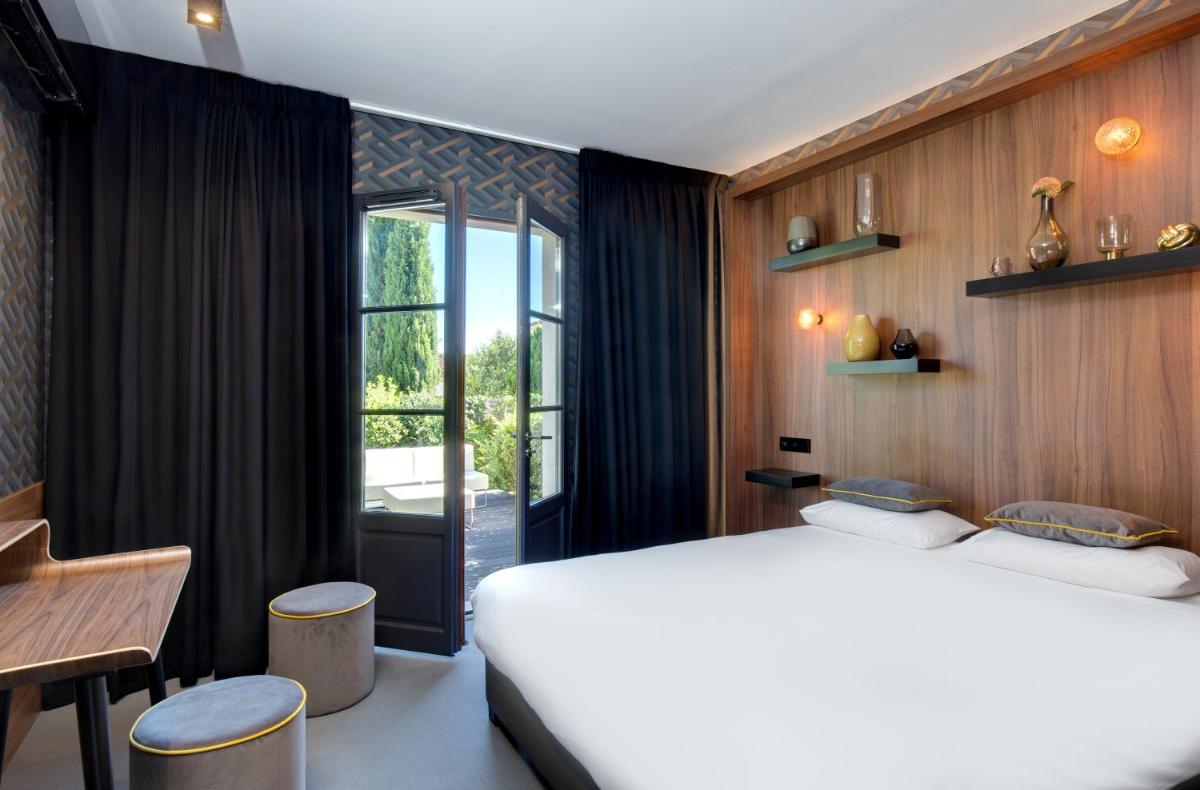 Un ou plusieurs lits dans un hébergement de l'établissement Hôtel Montmorency & Spa