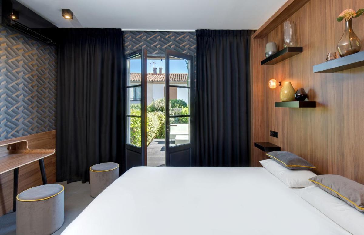 Un ou plusieurs lits dans un hébergement de l'établissement Hôtel Montmorency & Spa