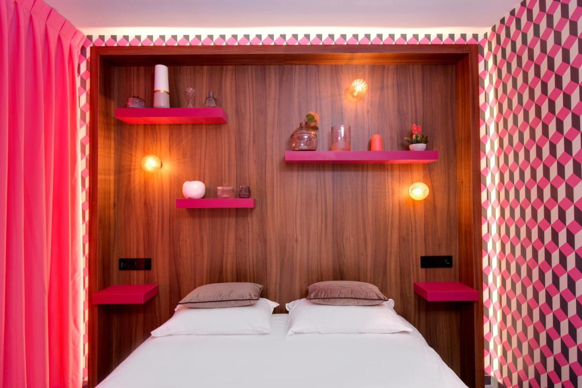 Un ou plusieurs lits dans un hébergement de l'établissement Hôtel Montmorency & Spa