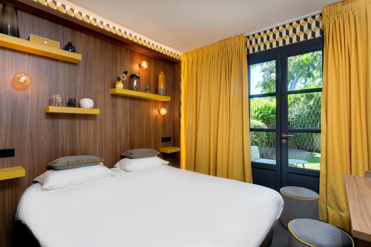 Un ou plusieurs lits dans un hébergement de l'établissement Hôtel Montmorency & Spa