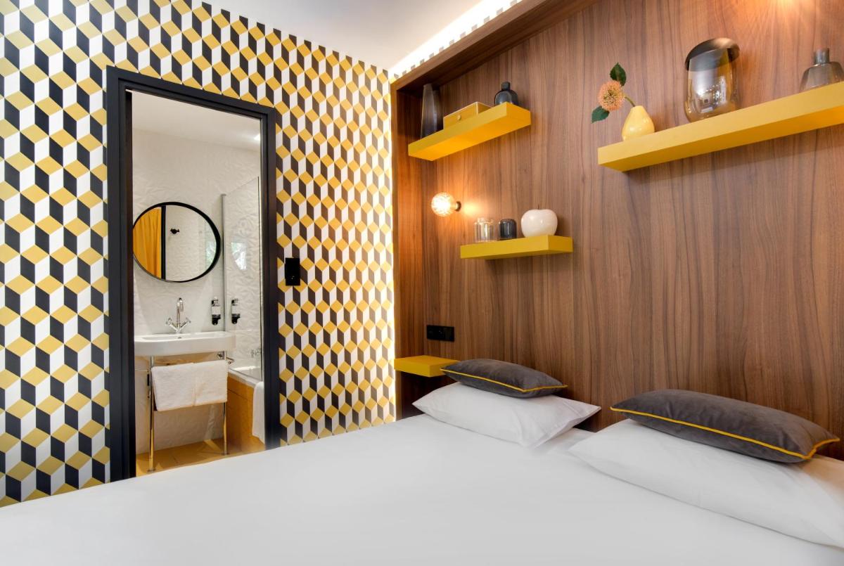 Un ou plusieurs lits dans un hébergement de l'établissement Hôtel Montmorency & Spa