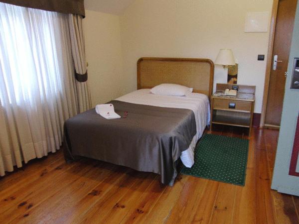 Uma cama ou camas num quarto em Palace Hotel & Spa - Termas de Sao Vicente