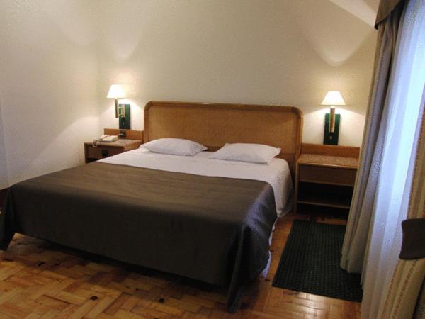 Uma cama ou camas num quarto em Palace Hotel & Spa - Termas de Sao Vicente