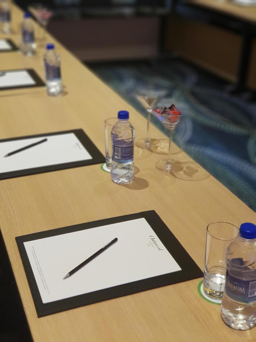 a table with glasses and bottles of water on it at Oakwood Residence Kapil Hyderabad in Hyderabad