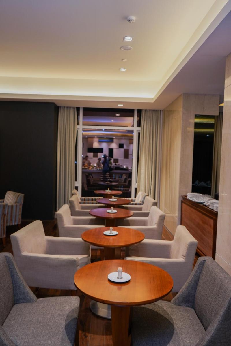 a row of tables and chairs in a restaurant at Oakwood Residence Kapil Hyderabad in Hyderabad