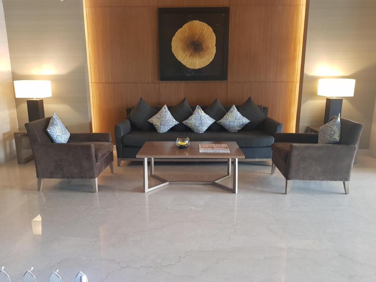 a living room with a couch and two chairs and a table at Oakwood Residence Kapil Hyderabad in Hyderabad