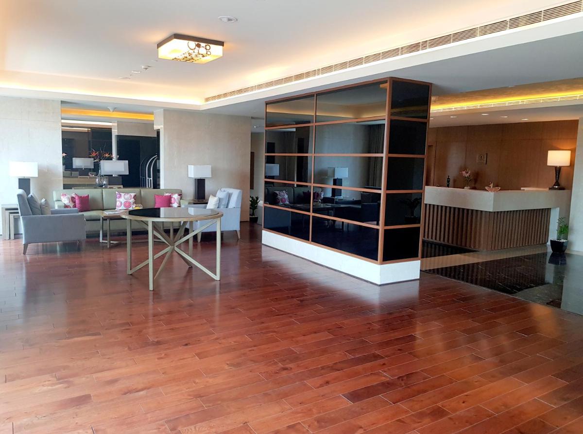 a living room with a table and a dining room at Oakwood Residence Kapil Hyderabad in Hyderabad