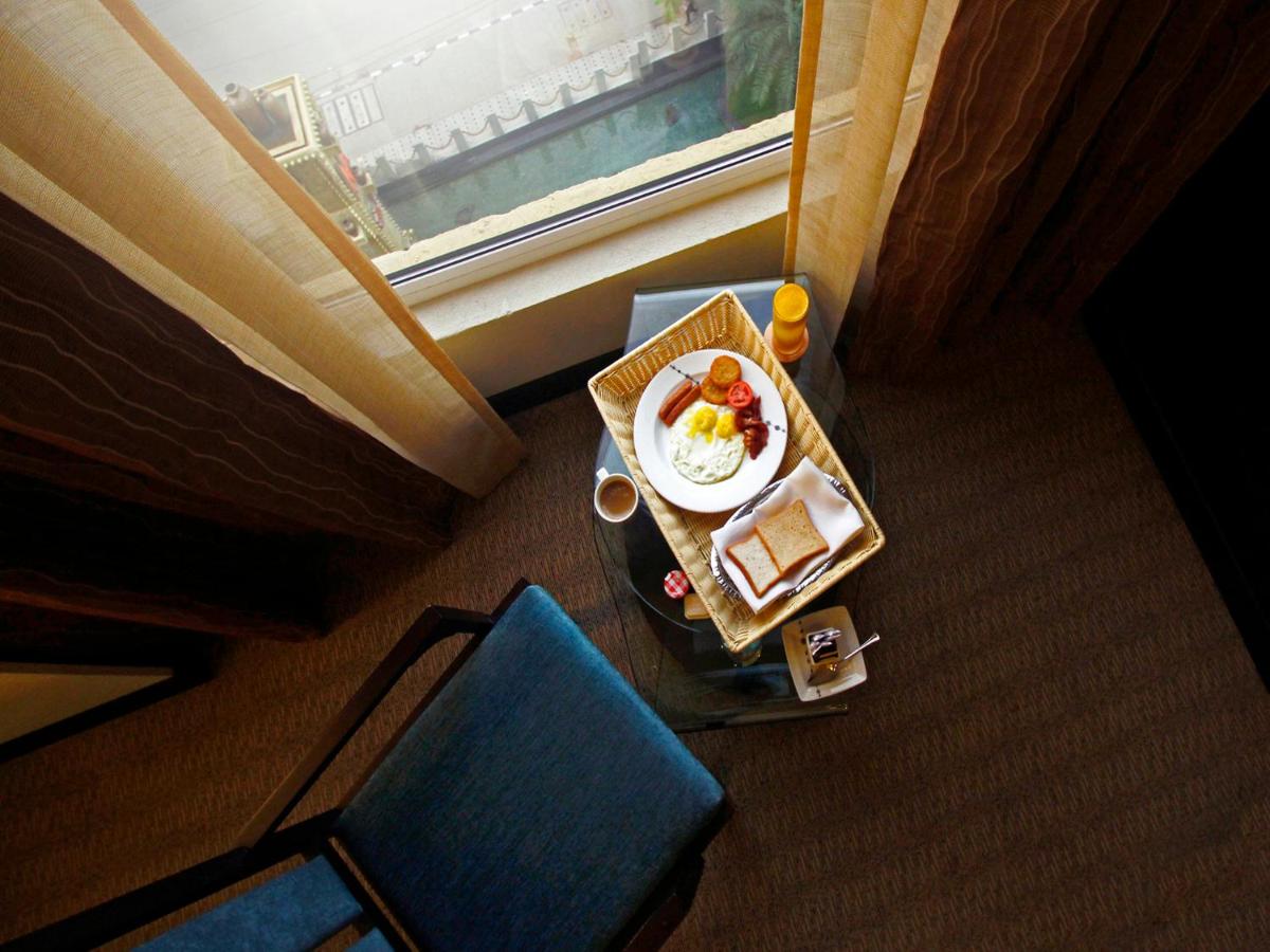 a plate of food on a table in a hotel room at Sterlings Mac Hotel in Bengaluru