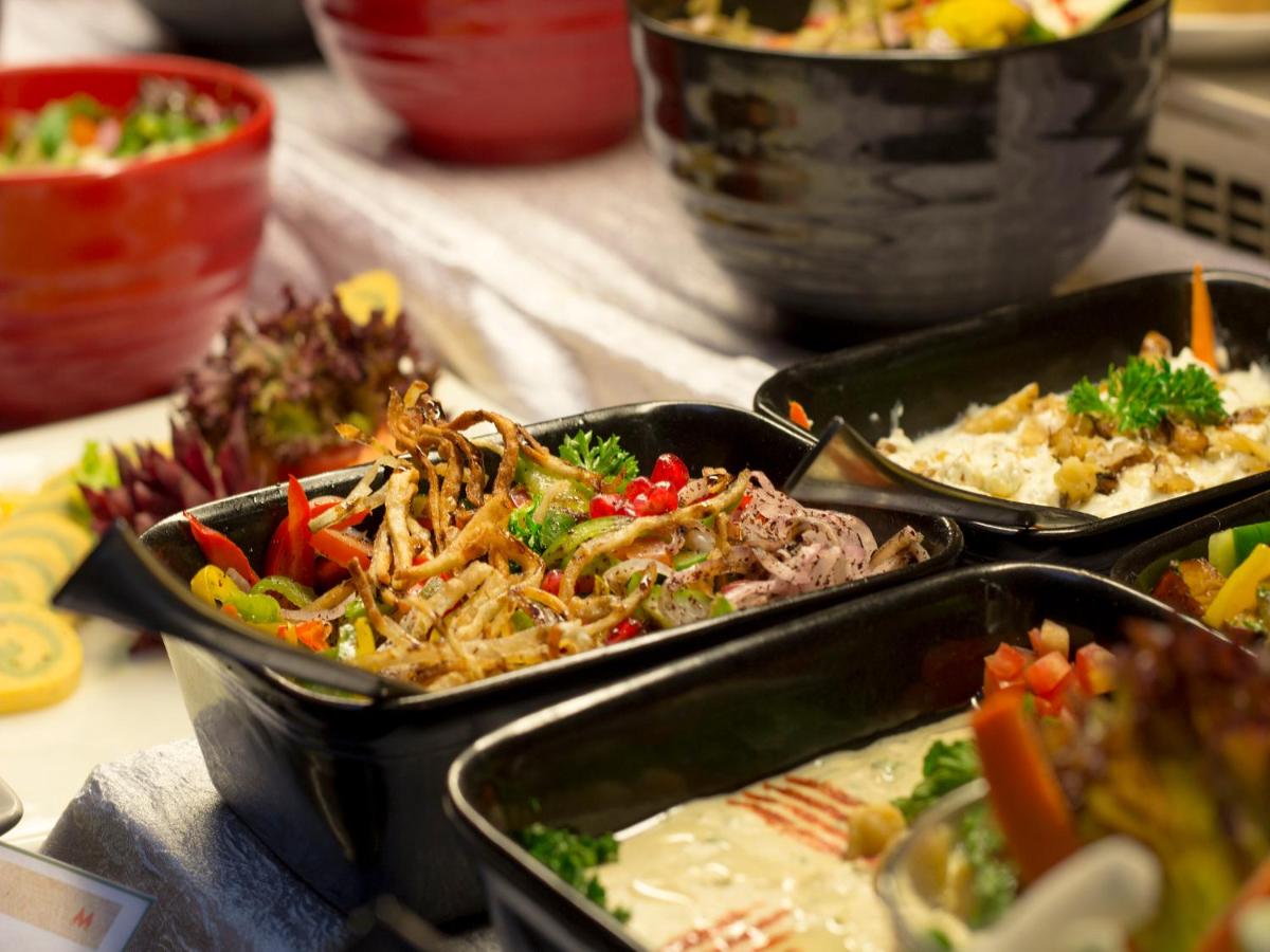 three trays of food on a table at Sterlings Mac Hotel in Bengaluru