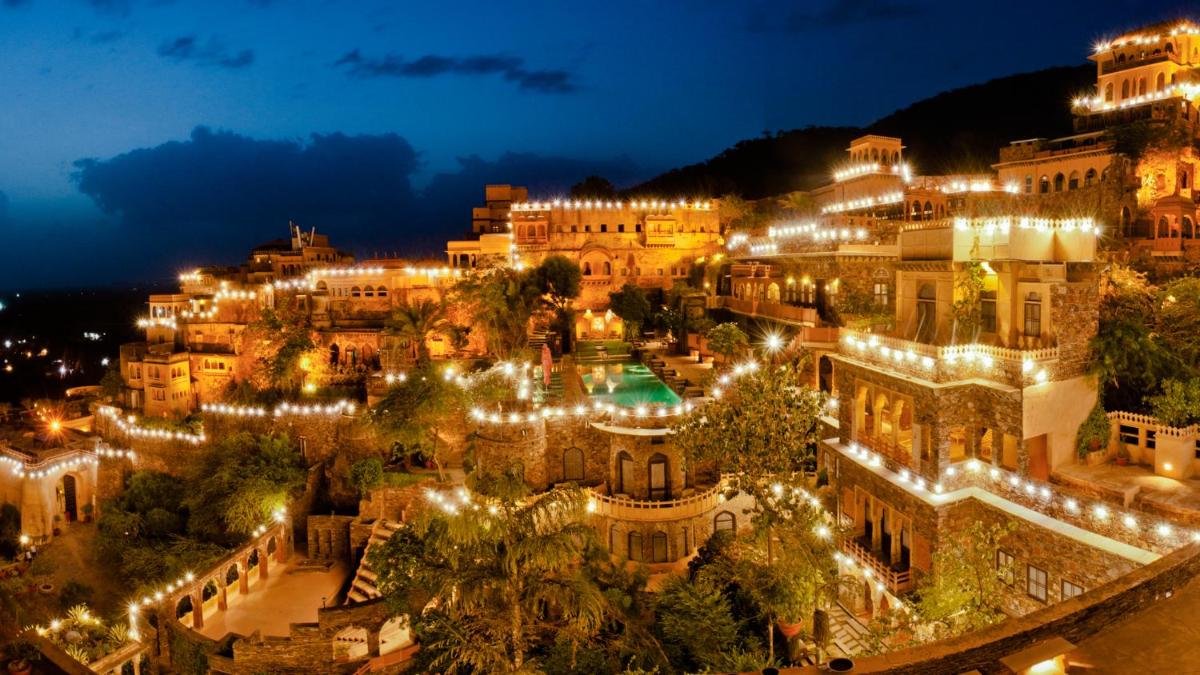 a city lit up at night with lights at Neemrana Fort-Palace in Neemrana