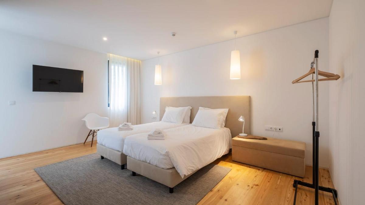 Uma cama ou camas num quarto em Aqua - Pópulo Eco Village