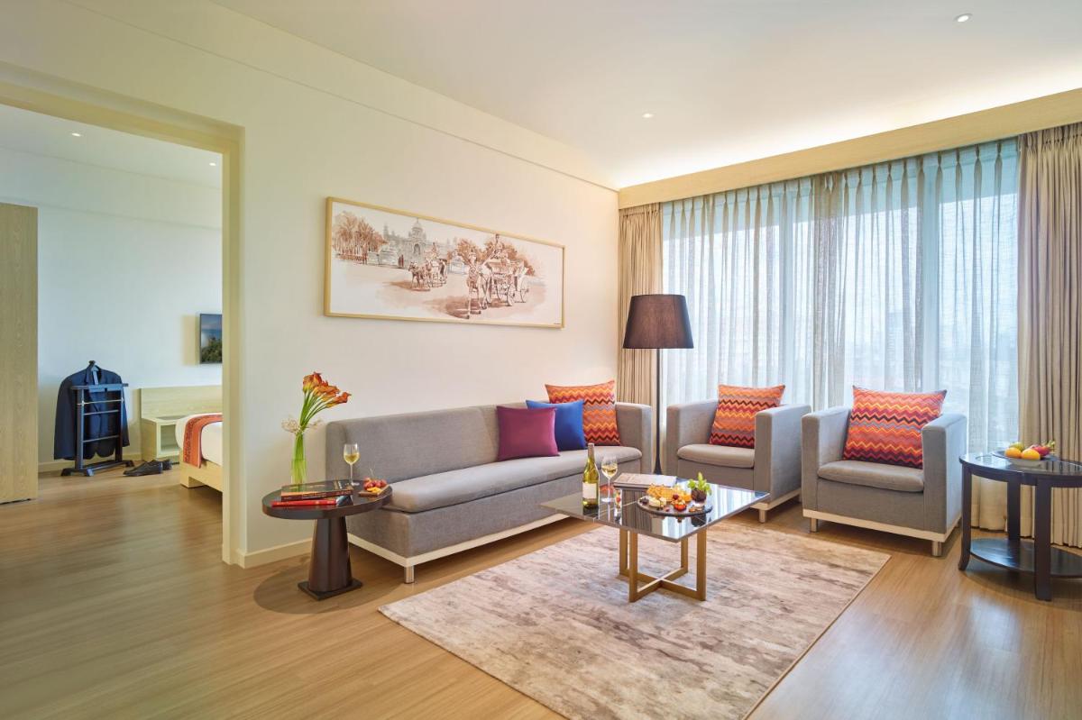 a living room with a couch and a table at Vivanta Kolkata EM Bypass in Kolkata