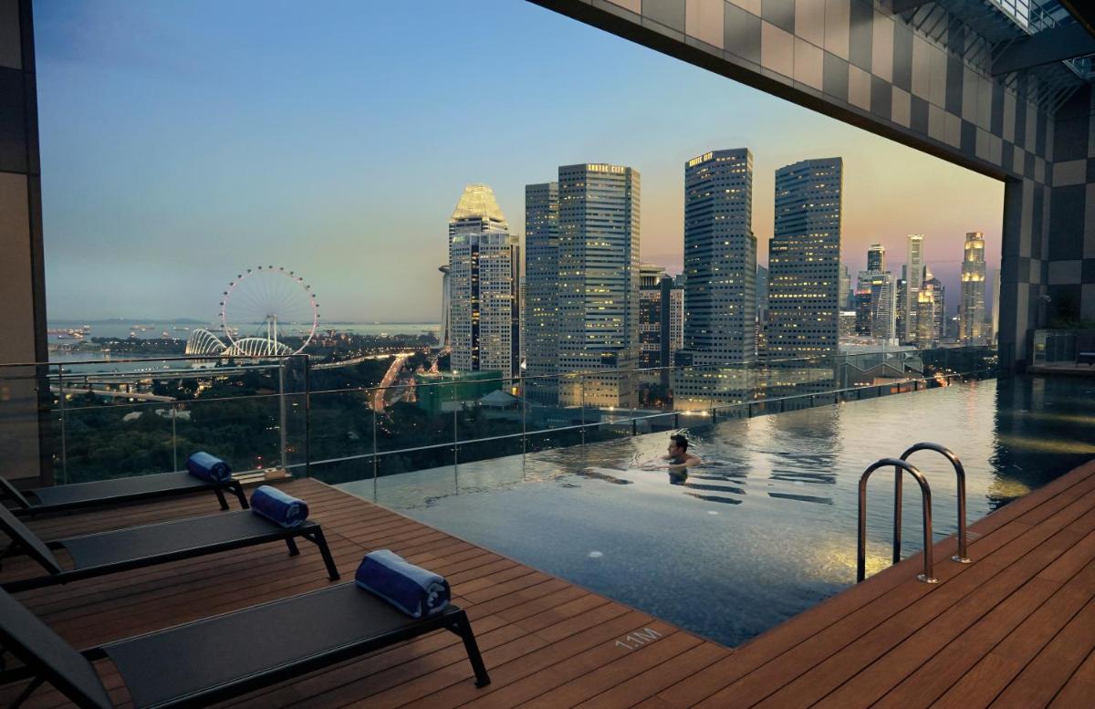 a view of a city skyline from a swimming pool at Pan Pacific Serviced Suites Beach Road, Singapore in Singapore