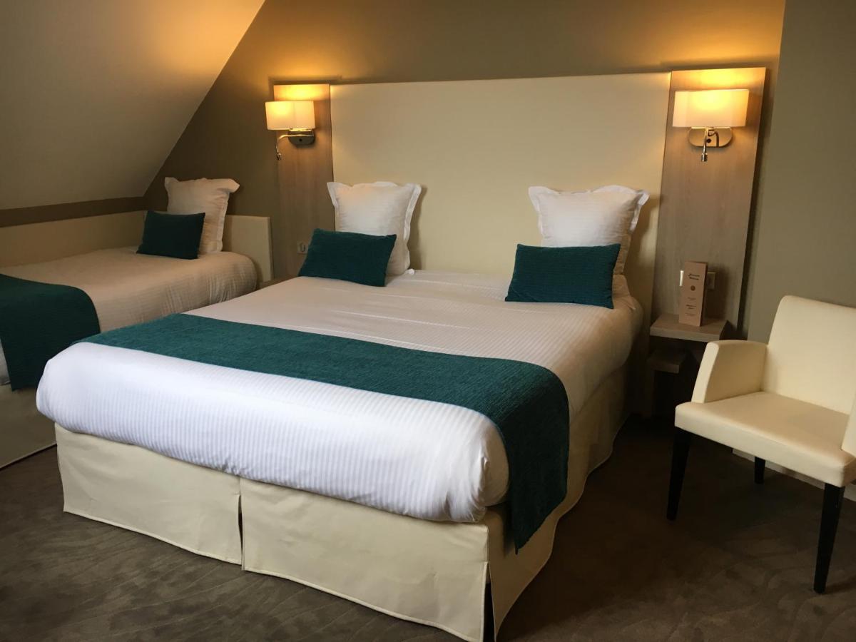 Un ou plusieurs lits dans un hébergement de l'établissement Hotel Normandy