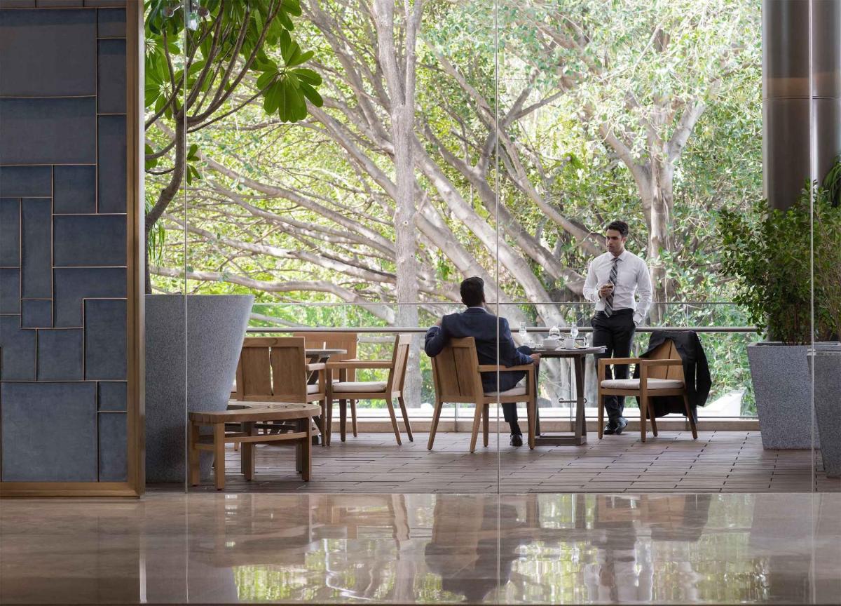 two people sitting at a table in a restaurant at Four Seasons Hotel Bengaluru at Embassy ONE in Bengaluru two people sitting at a table in a restaurant at Four Seasons Hotel Bengaluru at Embassy ONE in Bengaluru