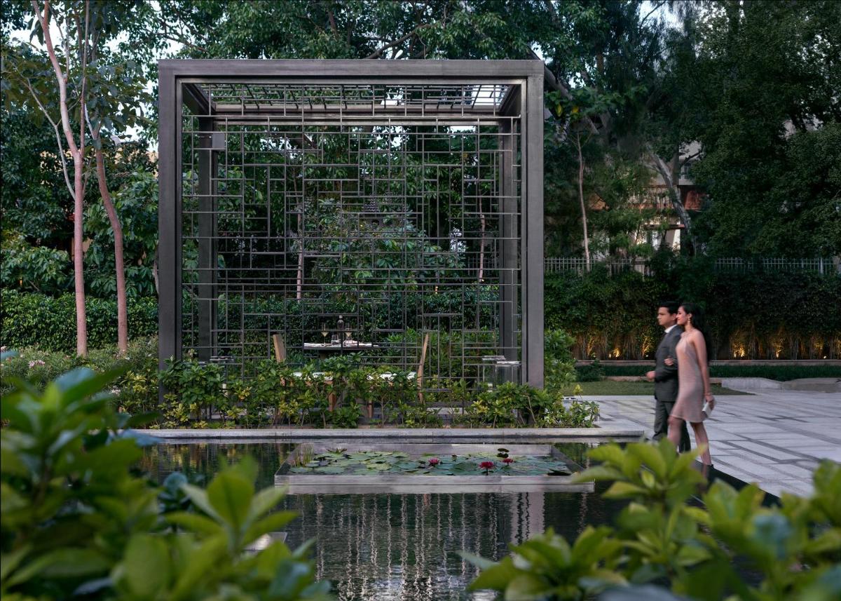 a man and a woman standing in front of a bird cage at Four Seasons Hotel Bengaluru at Embassy ONE in Bengaluru a man and a woman standing in front of a bird cage at Four Seasons Hotel Bengaluru at Embassy ONE in Bengaluru
