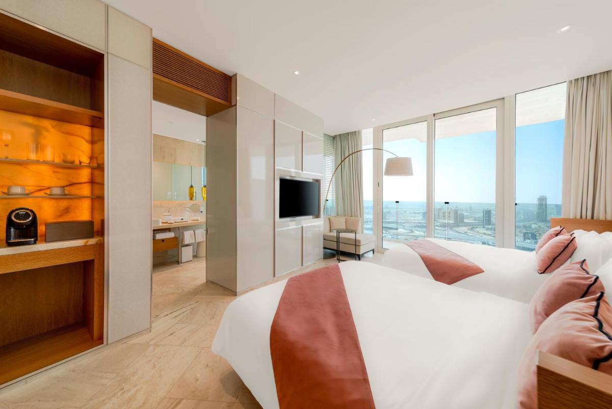 a hotel room with a bed and a television at FIVE Jumeirah Village in Dubai
