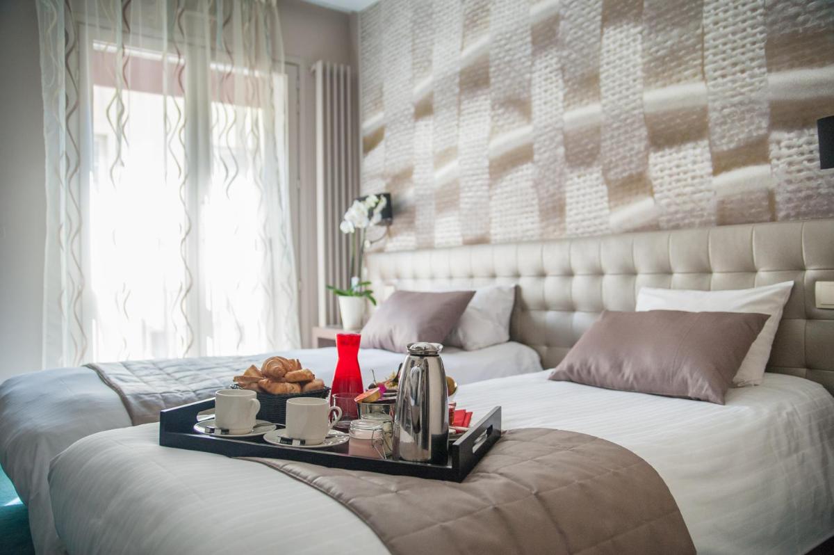 Un ou plusieurs lits dans un hébergement de l'établissement Logis Hôtel Restaurant Le Fruitier