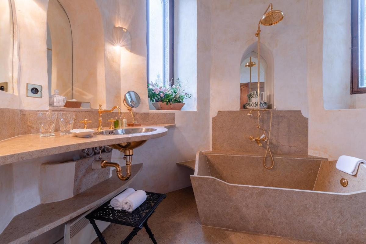 une salle de bain avec une grande baignoire et un lavabo dans l'établissement Château De Riell, à Molitg-les-Bains