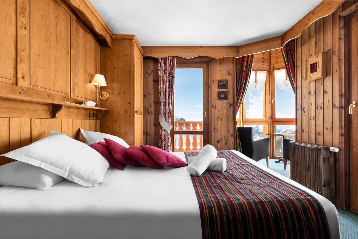 Un ou plusieurs lits dans un hébergement de l'établissement Hôtel Les Balcons Village