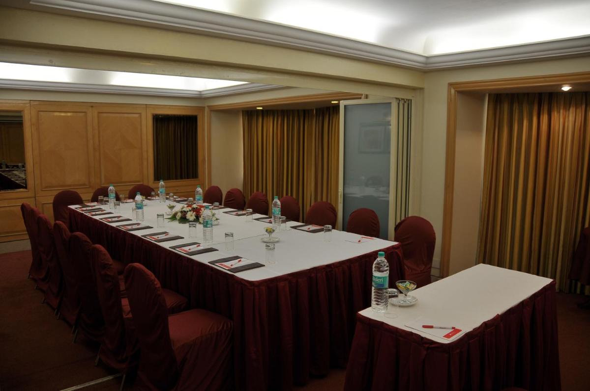 a large conference room with a long table and chairs at Ramada Plaza By Wyndham Palm Grove in Mumbai