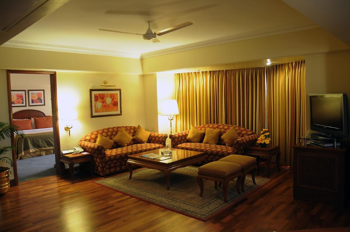 a living room with a couch and a coffee table at Ramada Plaza By Wyndham Palm Grove in Mumbai