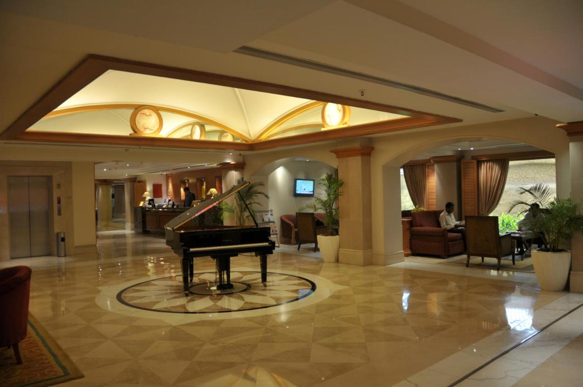 a piano in the lobby of a hotel at Ramada Plaza By Wyndham Palm Grove in Mumbai