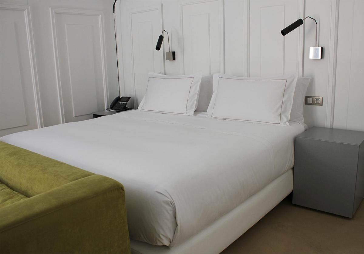 Cama o camas de una habitación en EME Catedral Mercer Hotel
