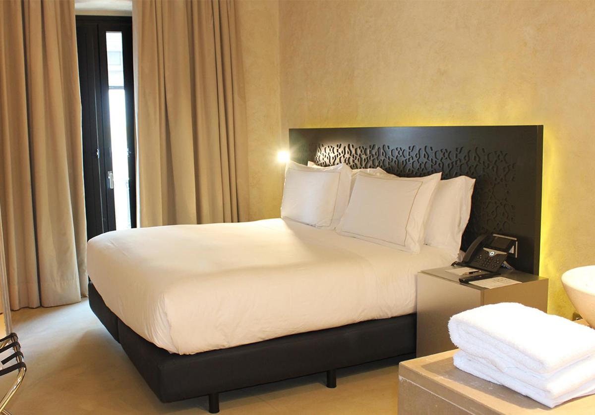 Cama o camas de una habitación en EME Catedral Mercer Hotel