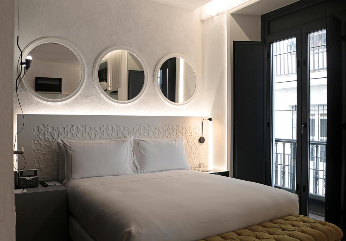 Cama o camas de una habitación en EME Catedral Mercer Hotel