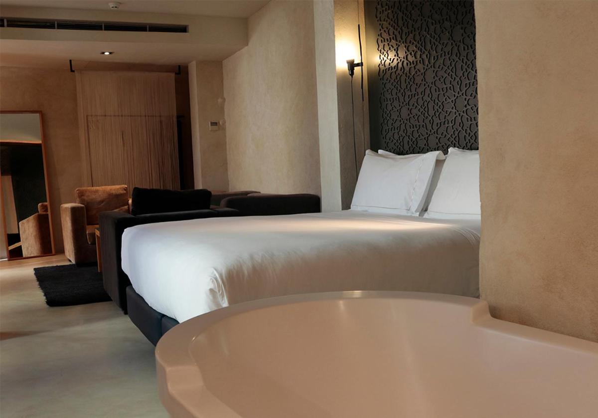 Cama o camas de una habitación en EME Catedral Mercer Hotel