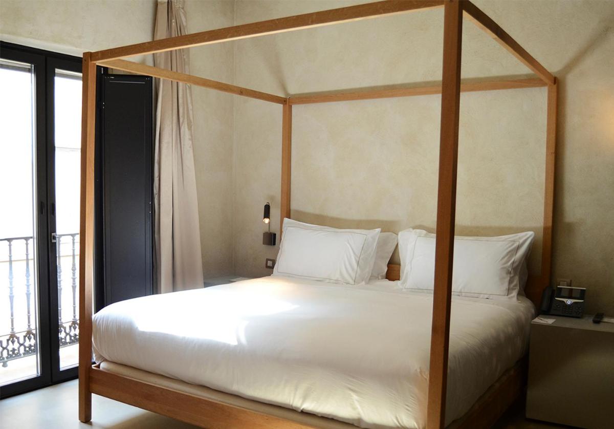 Cama o camas de una habitación en EME Catedral Mercer Hotel