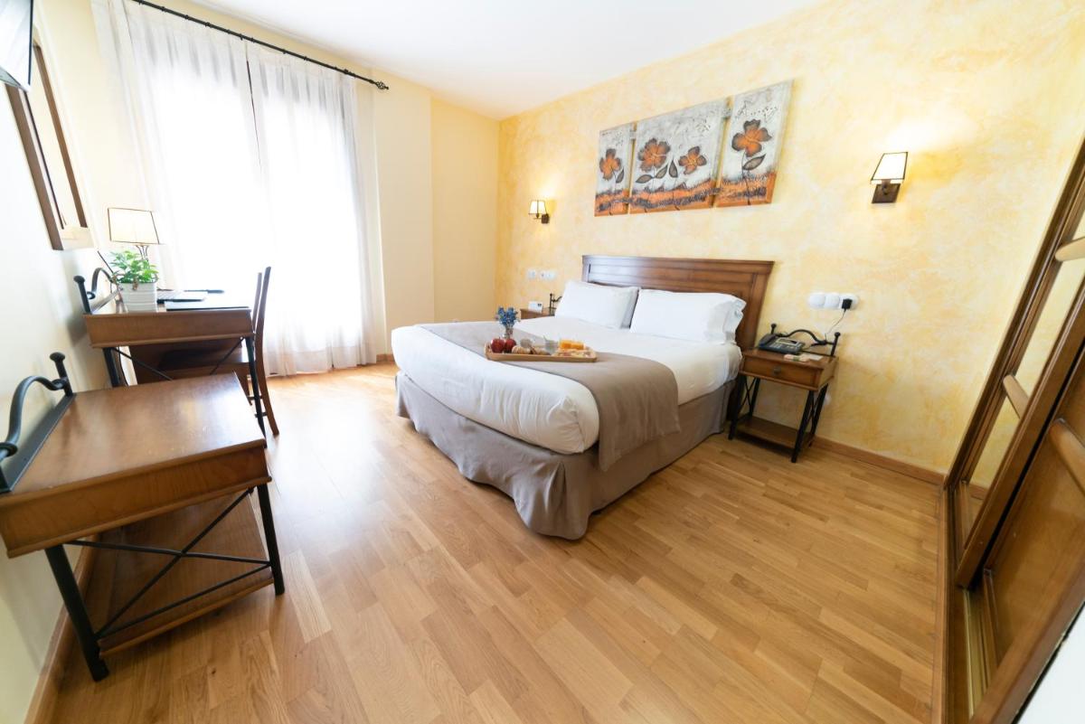 Cama o camas de una habitación en Hotel Comendador