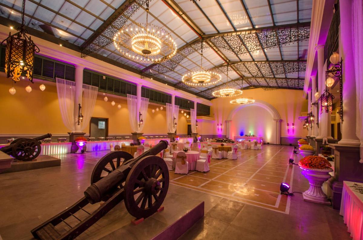 a banquet hall with a cannon in the middle of it at Raajkutir - IHCL SeleQtions in Kolkata