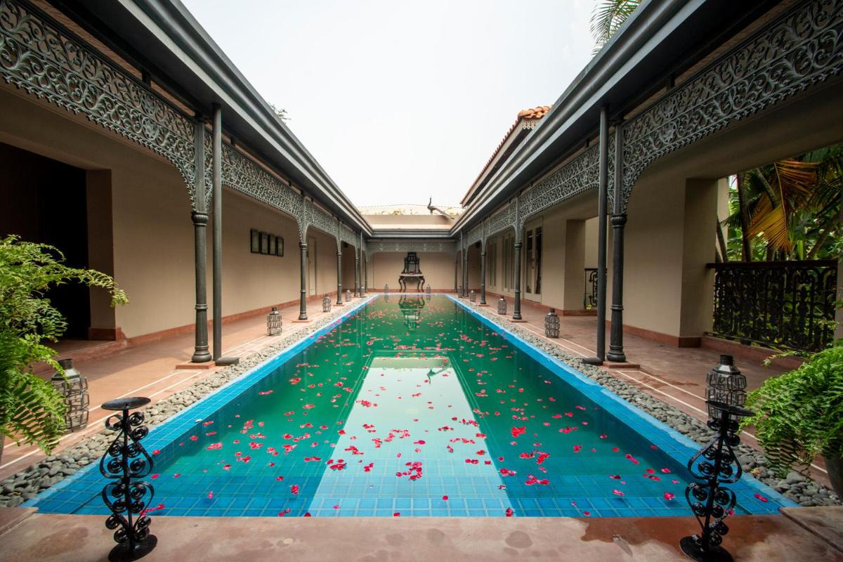 a swimming pool filled with lots of red balls at Raajkutir - IHCL SeleQtions in Kolkata