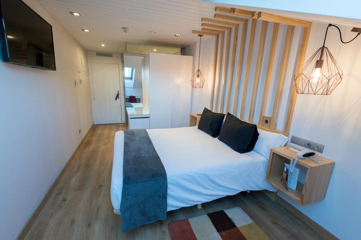 Cama o camas de una habitación en Hotel Fruela