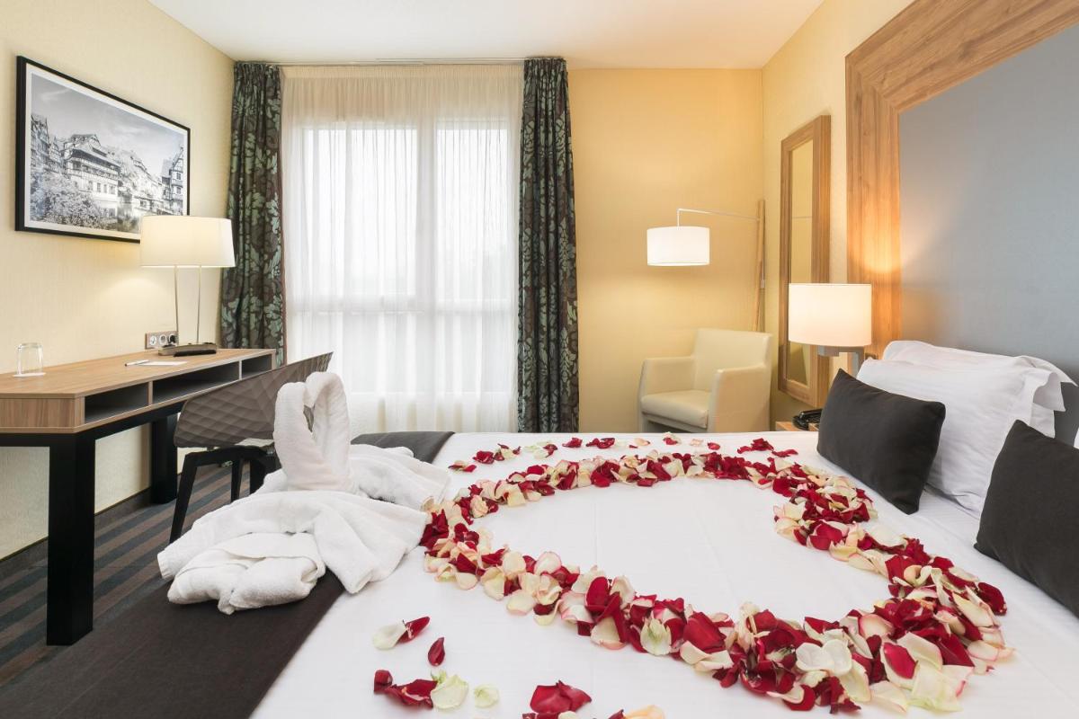 Un ou plusieurs lits dans un hébergement de l'établissement 7Hotel&Spa