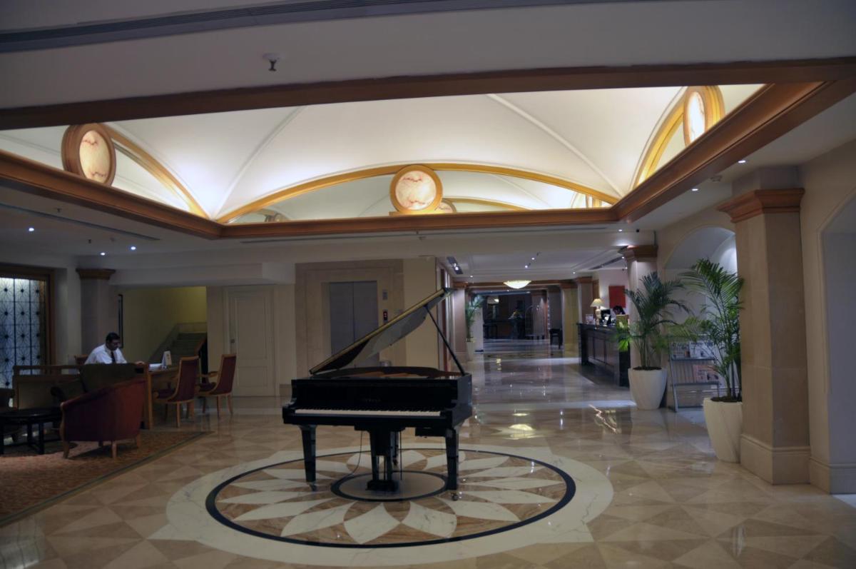 a piano in the lobby of a hotel at Ramada Plaza By Wyndham Palm Grove in Mumbai