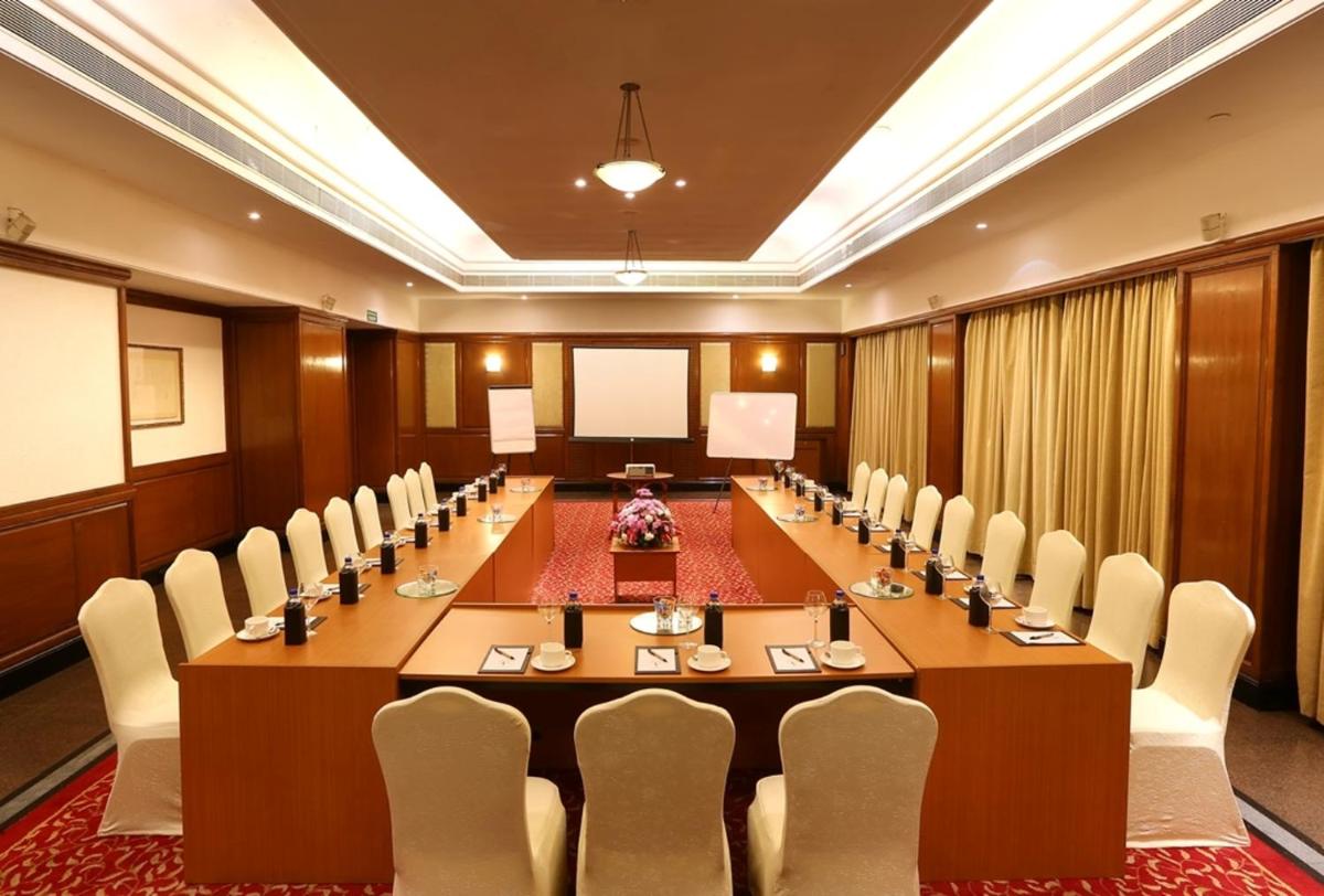 a large conference room with a long table and chairs at Greenpark Chennai in Chennai