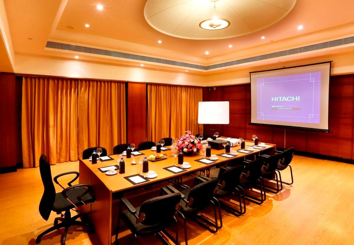 a meeting room with a long table and chairs at Greenpark Chennai in Chennai