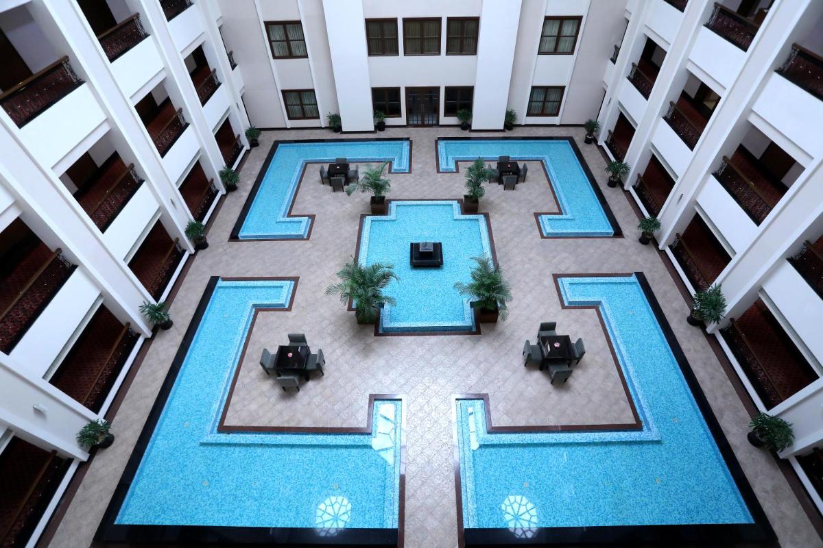 an overhead view of a pool in a hotel lobby at Greenpark Chennai in Chennai