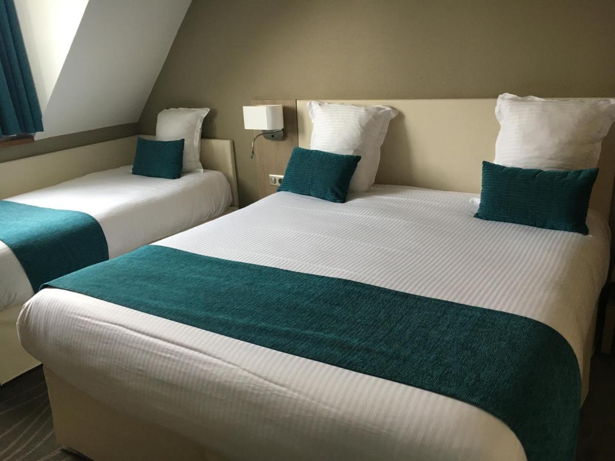 Un ou plusieurs lits dans un hébergement de l'établissement Hotel Normandy