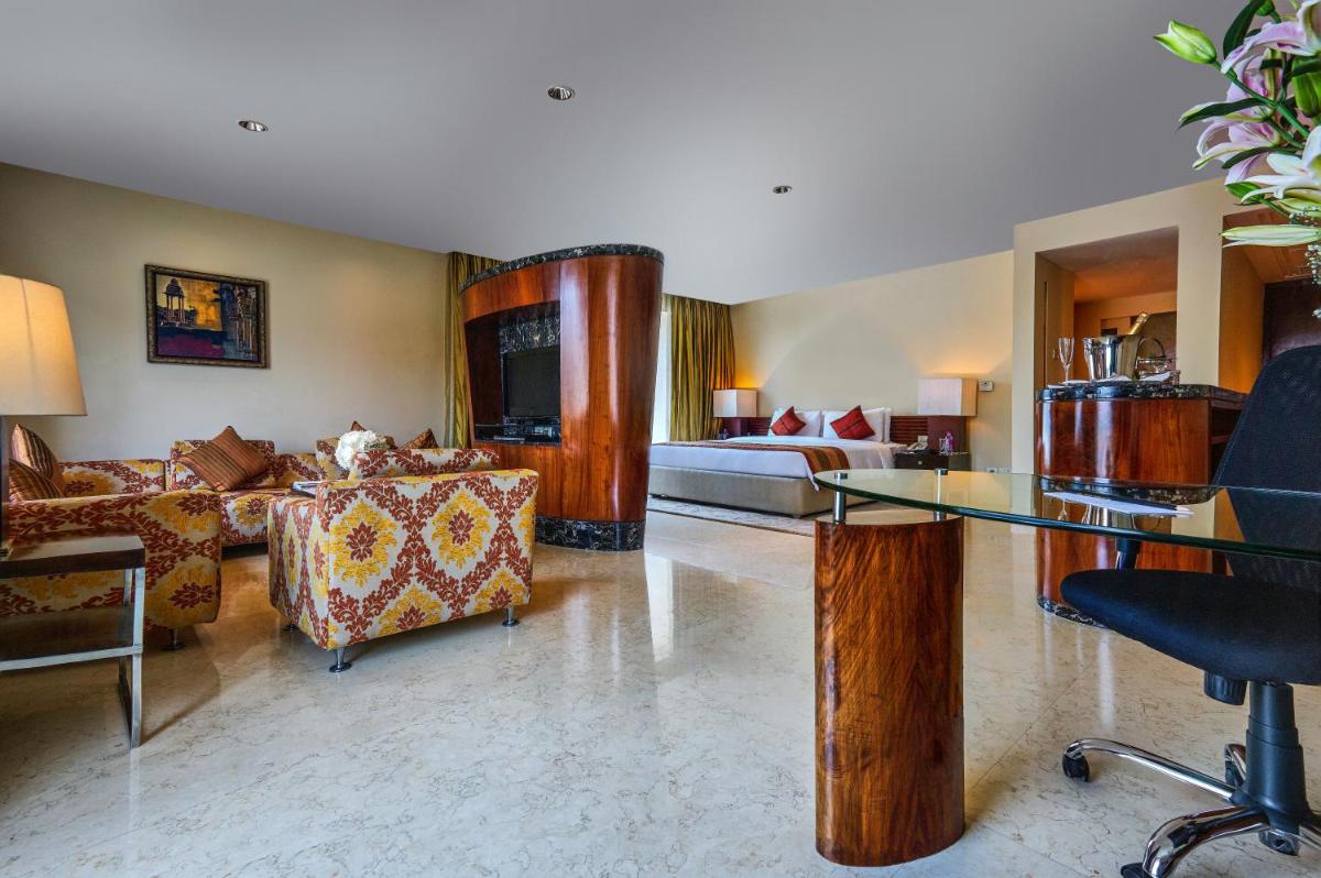a living room with a couch and a table at Taj Club House in Chennai