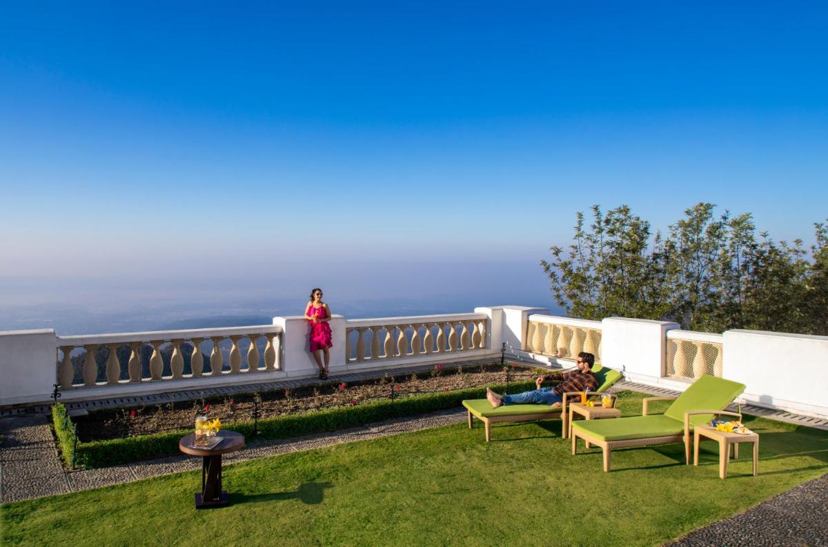 a man and a woman standing on a balcony at Jaypee Residency Manor in Mussoorie
