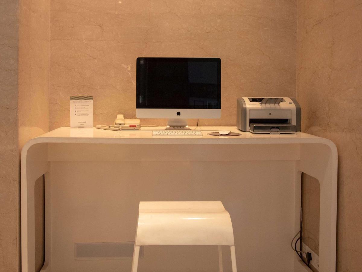 a desk with a computer and a printer on it at Mercure Hyderabad KCP Banjara Hills, An Accor Hotel in Hyderabad