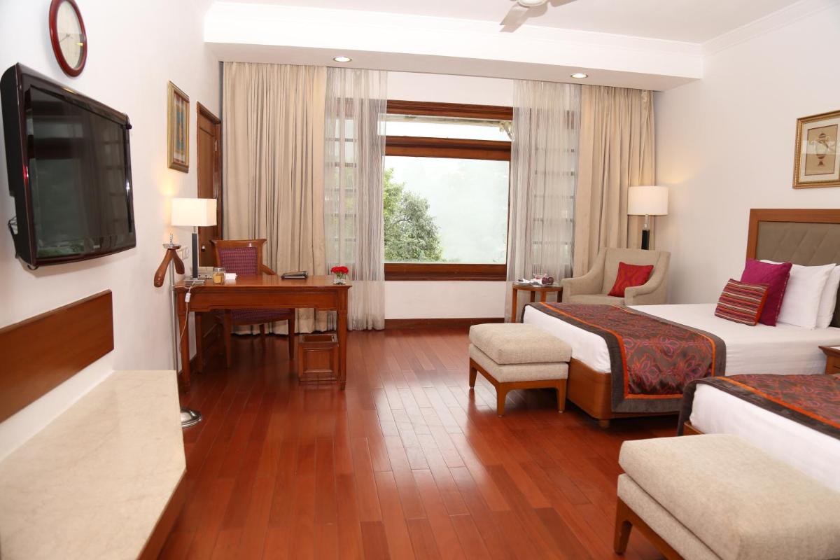 a hotel room with two beds and a television at Jaypee Residency Manor in Mussoorie