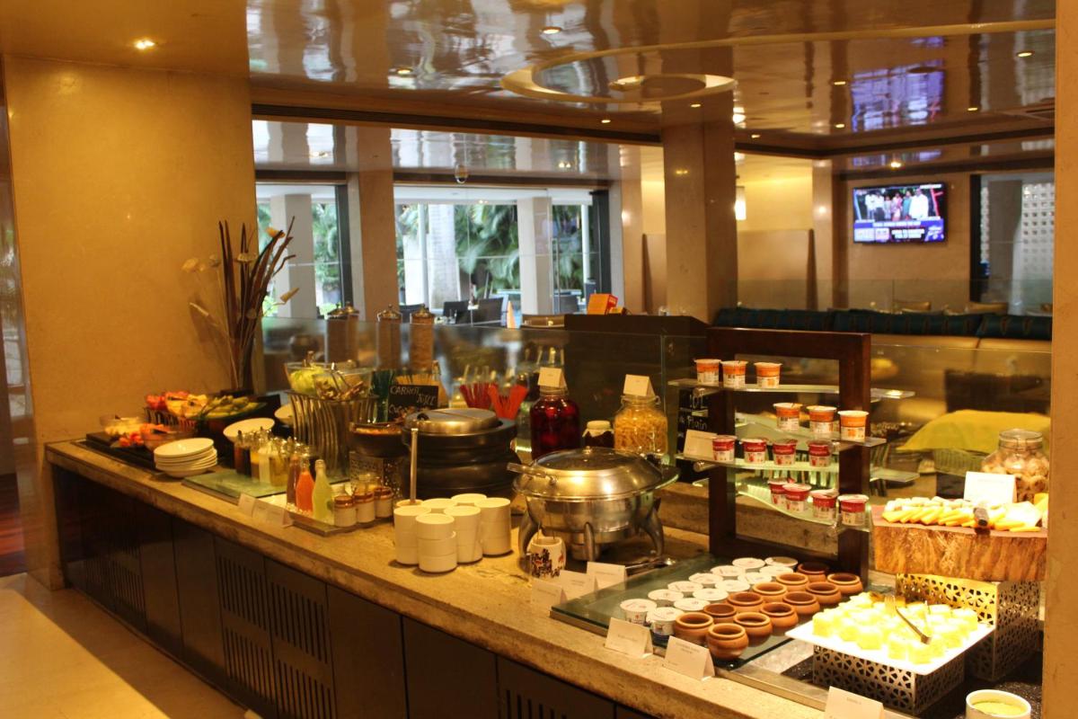a buffet line with food on display in a restaurant at Blue Diamond Pune IHCL SeleQtions in Pune